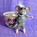 Little mouse comes out of her cup